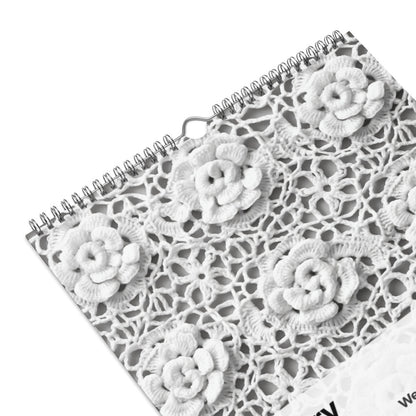 Spiral-bound notebook with a lacy floral pattern cover.