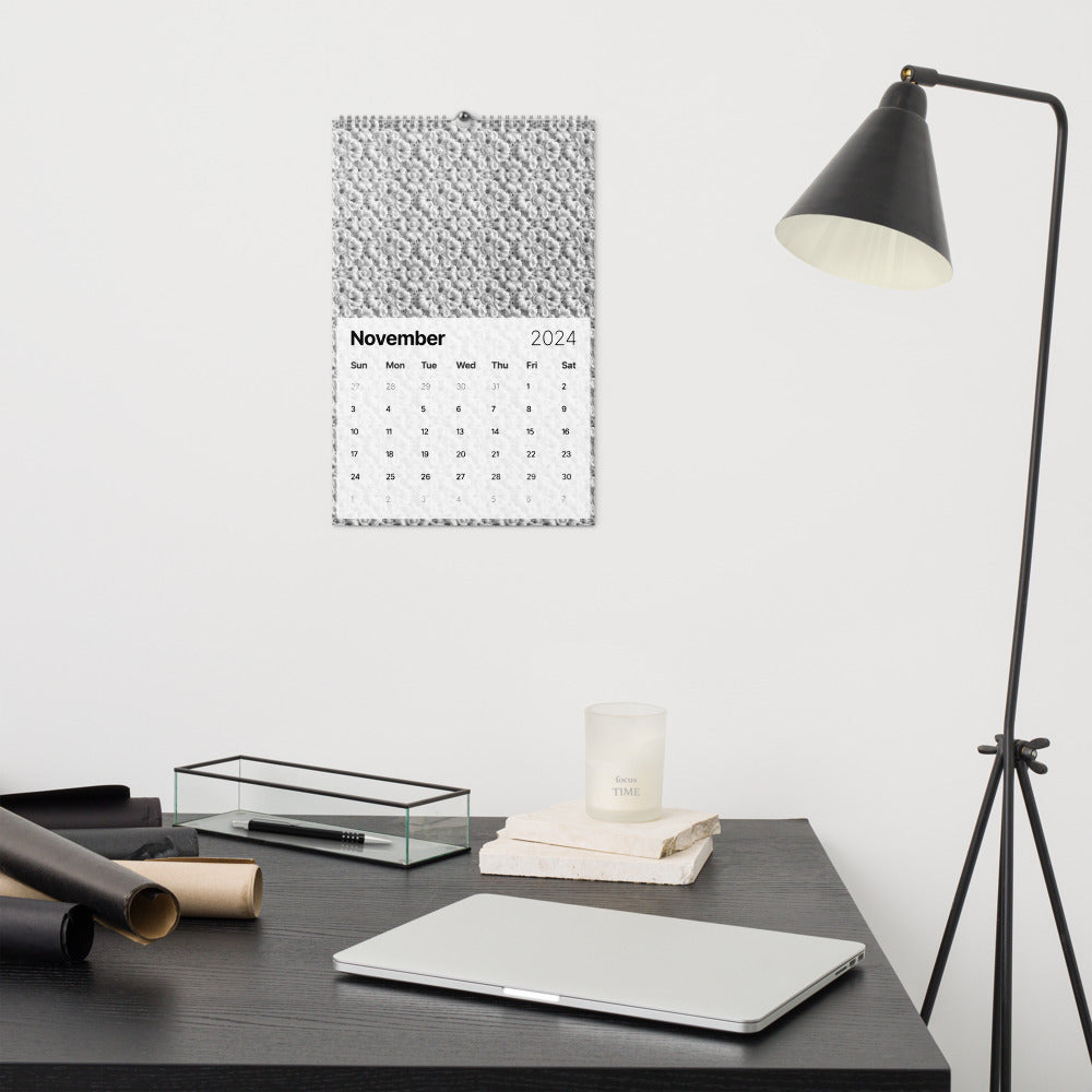 Minimalist desk setup with a laptop, lamp, calendar, and office supplies.