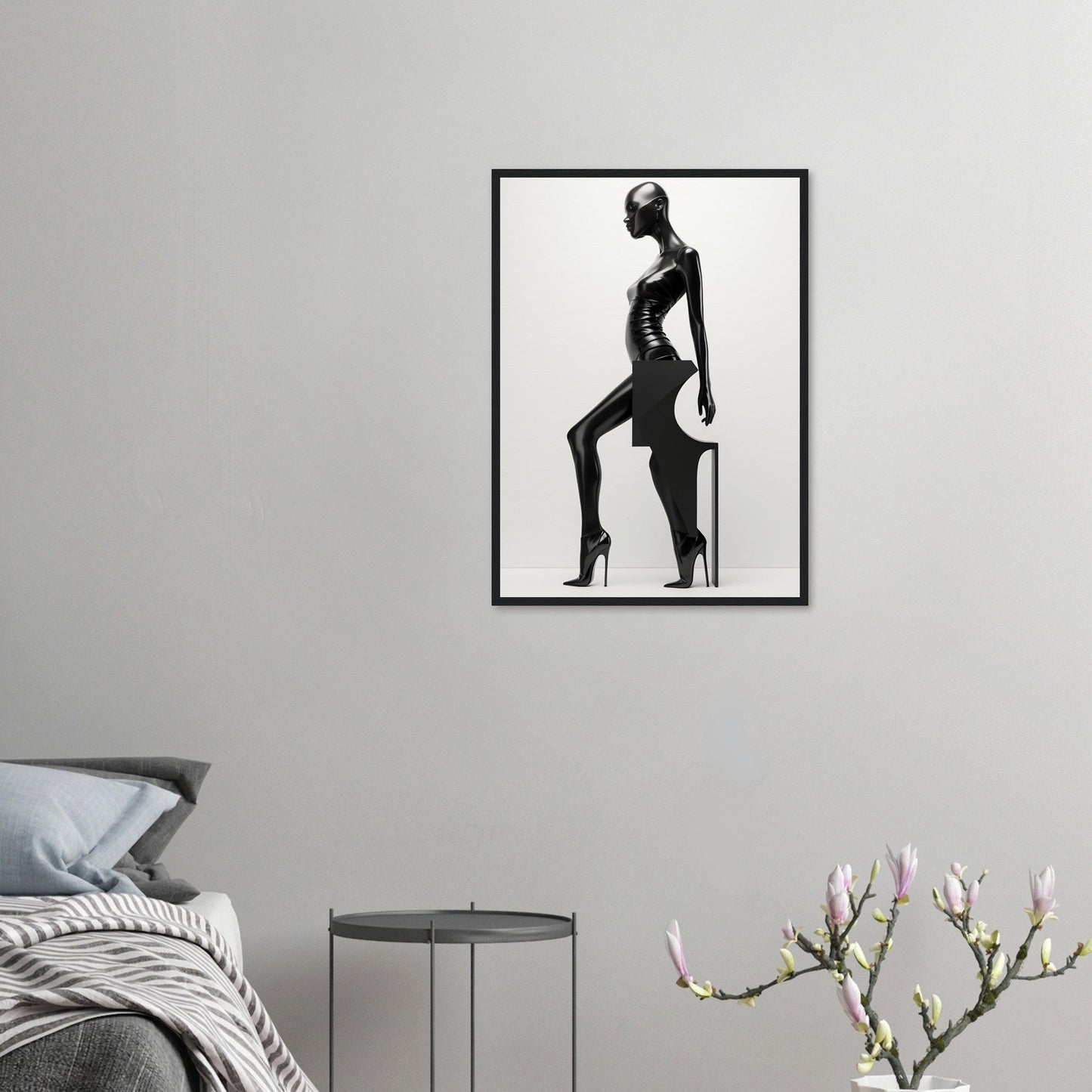 Black and white photograph of a silhouetted figure in a striking pose, framed and mounted on a wall.