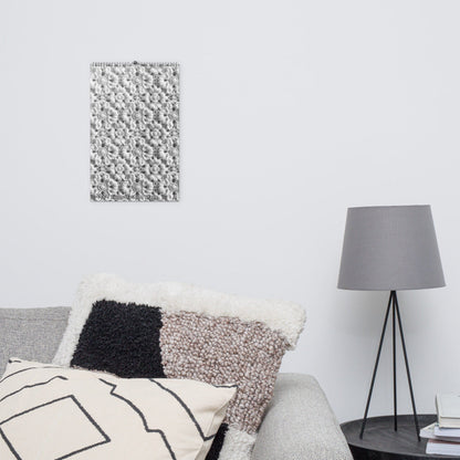 Minimalist bedroom corner with a bed, decorative wall art, and tripod floor lamp.