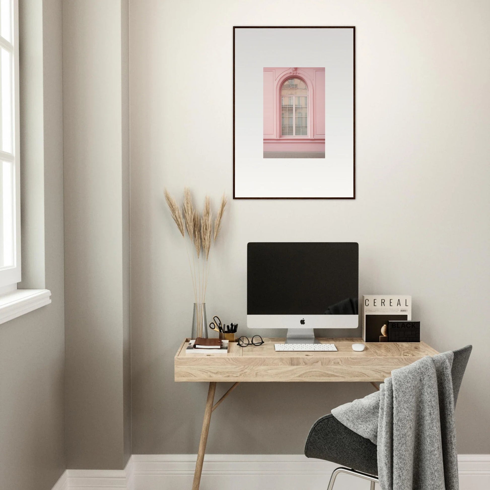 Minimalist wooden desk with iMac and Pink Sonata Vibrations artwork above