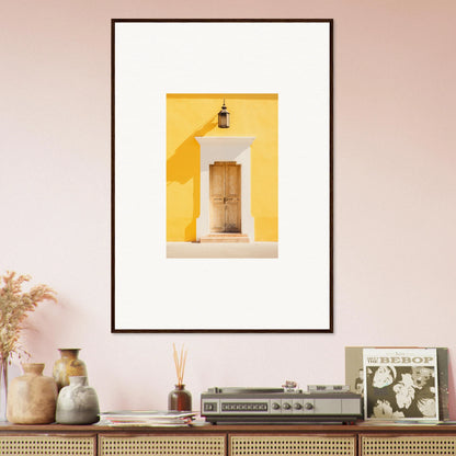 Framed wall art of a yellow building’s doorway with a lantern for the Golden Hue Portal