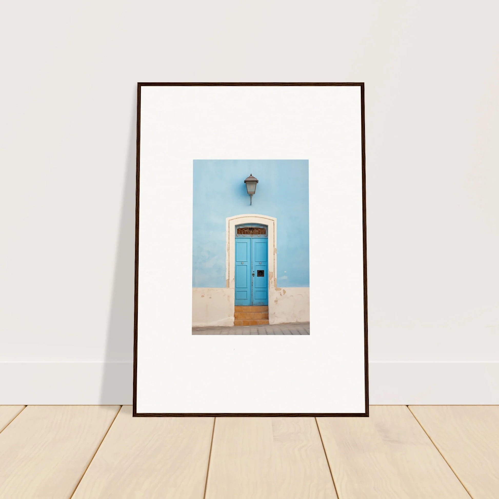 Framed wall art of a bright blue door on a light blue wall, Surreal Azure Vesaurrezz