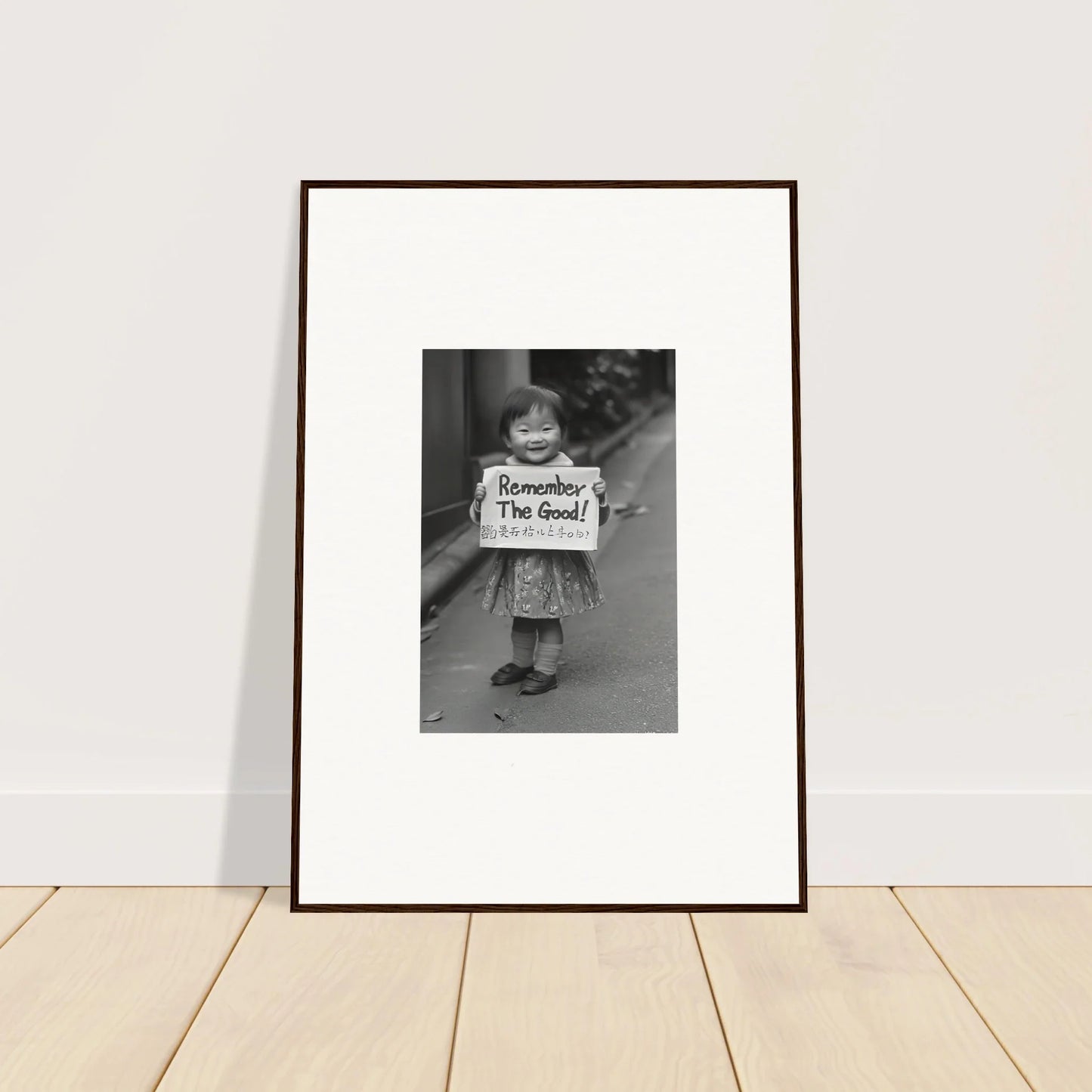 Framed black and white photo of a child with Remember I’m fine sign for Whimsy Echo Memory