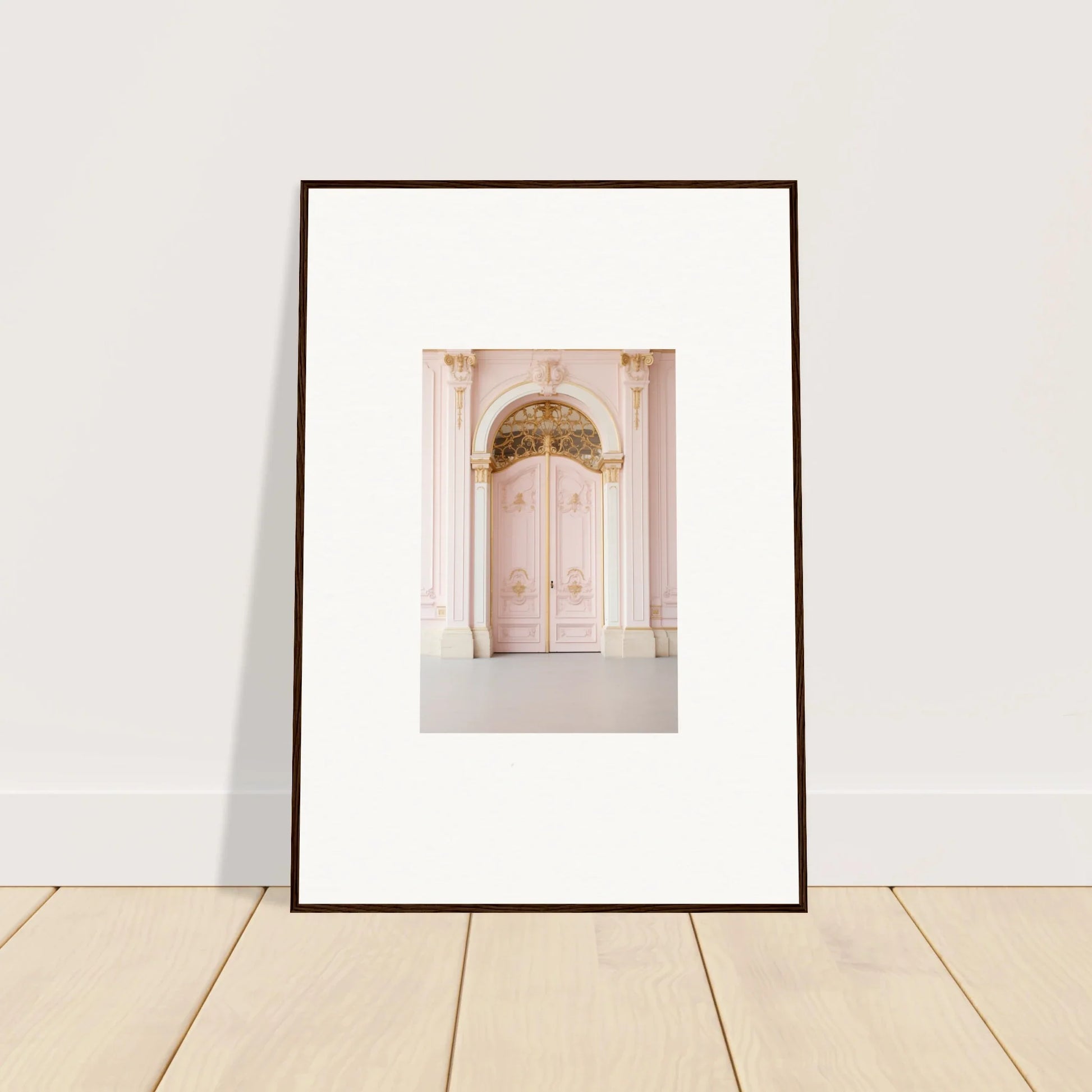 Framed wall art of a pale pink door with decorative molding from Regal Must collection