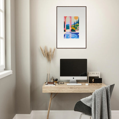 Minimalist home office with a wooden desk, computer, and colorful canvas print wall art