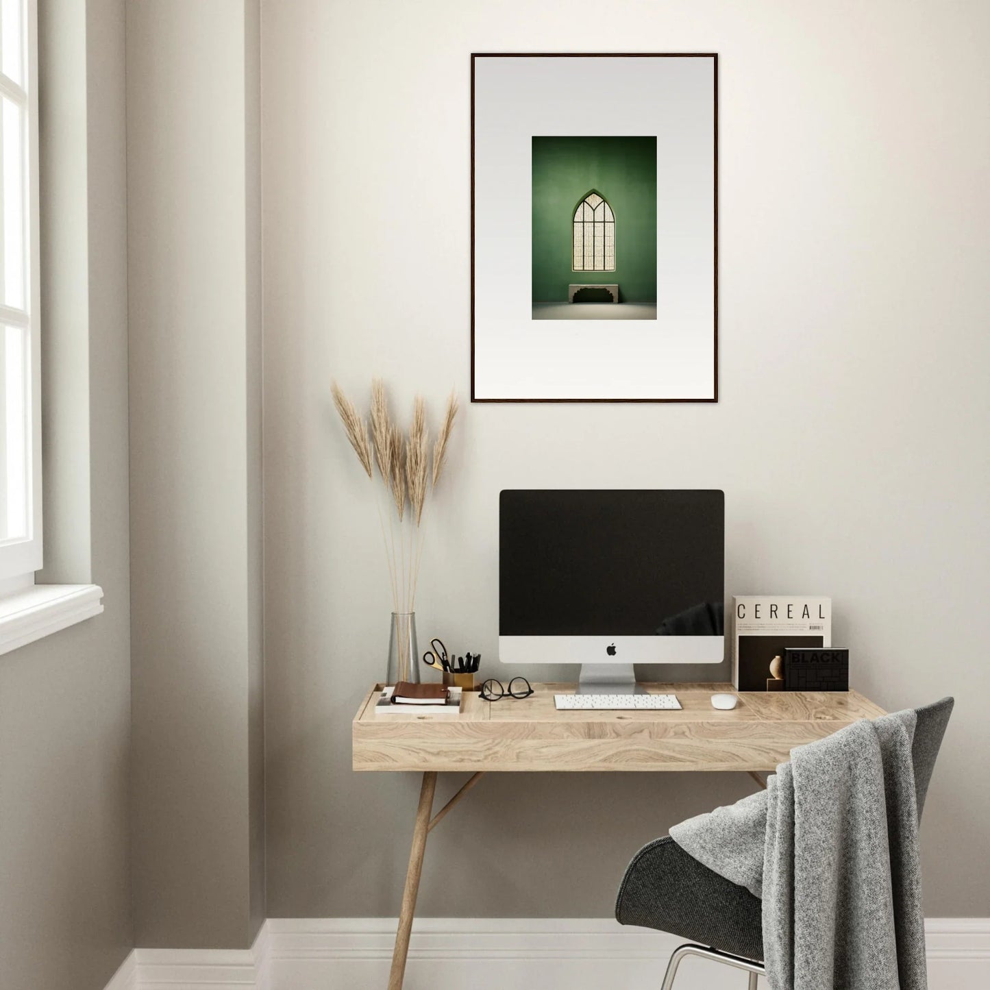 Minimalist wooden desk with iMac and artwork, perfect for Evermind Greenthaum vibes