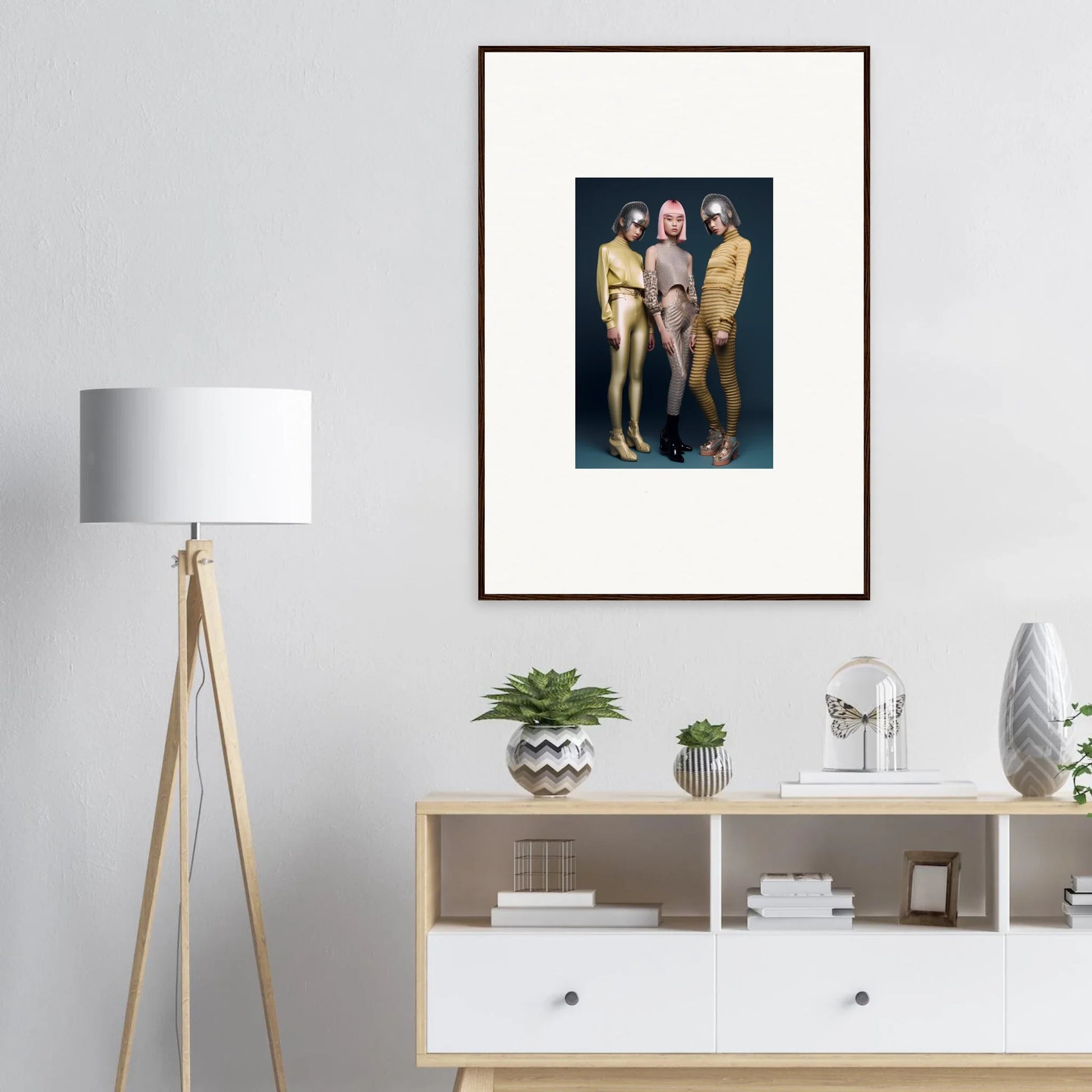 Framed wall art of three figures in gold, gray, and yellow from Galactic Fashion Paradigm