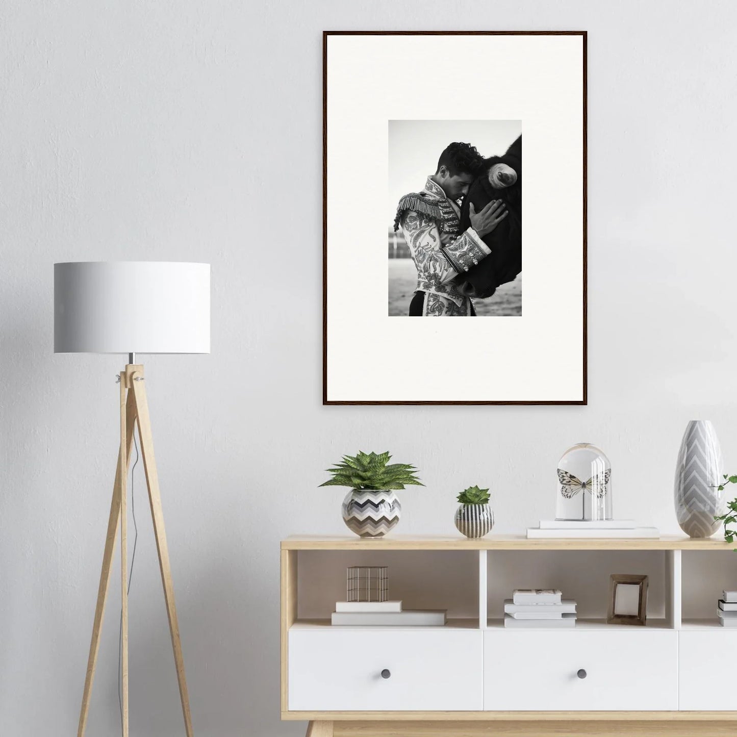 Black and white framed photograph on light gray wall for Triumphant Shadows Embrace art