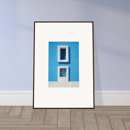 Framed wall art of a bright blue wall with white-trimmed windows from Isles Encompassed Vista