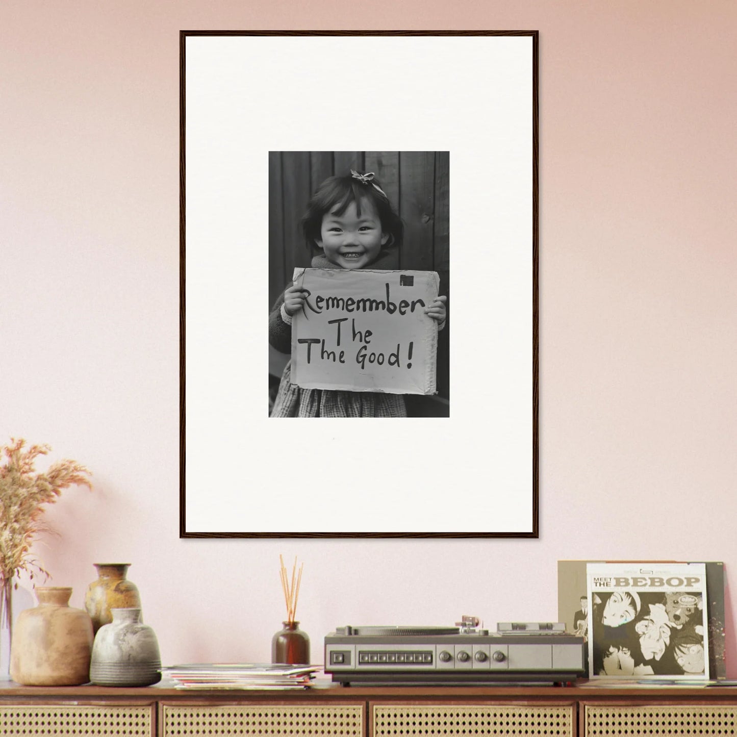 Framed black and white photo of a child with a sign for Timeless Joy Parade art