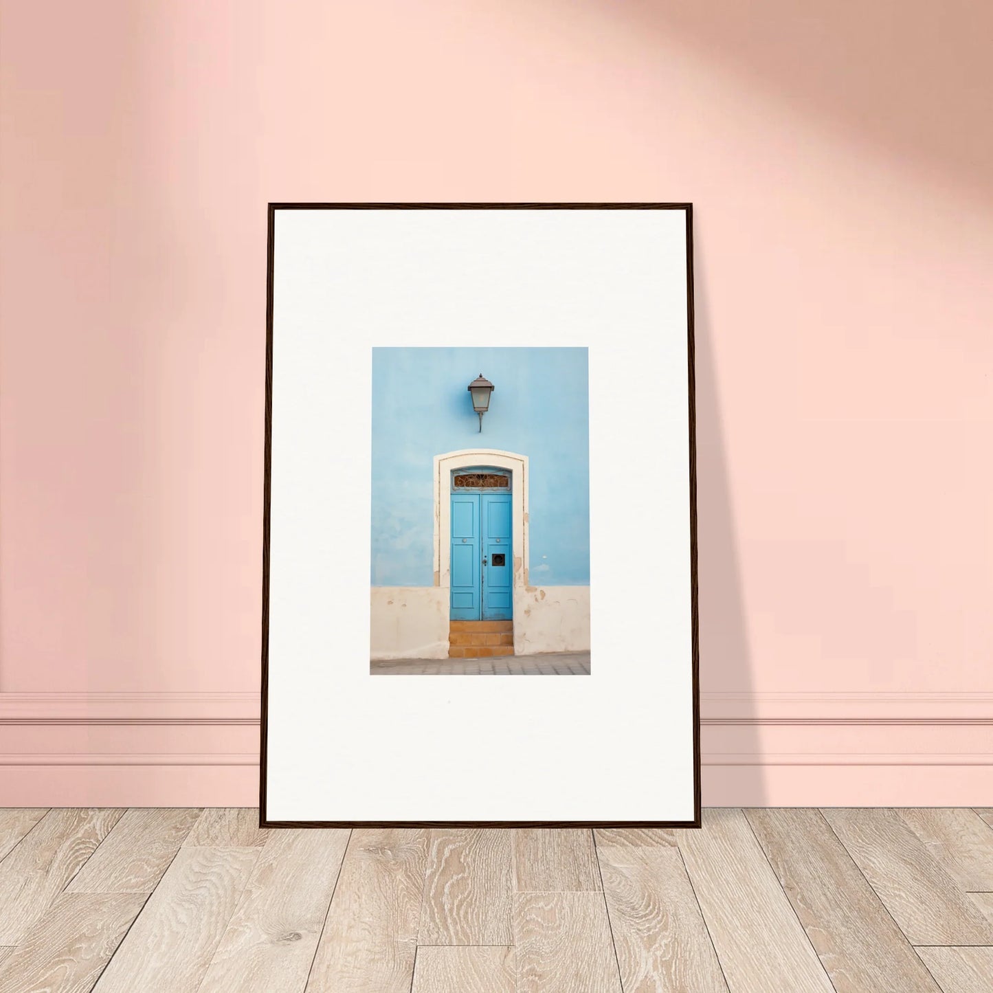 Framed wall art of a blue door on a light blue wall, part of Surreal Azure Vesaurrezz