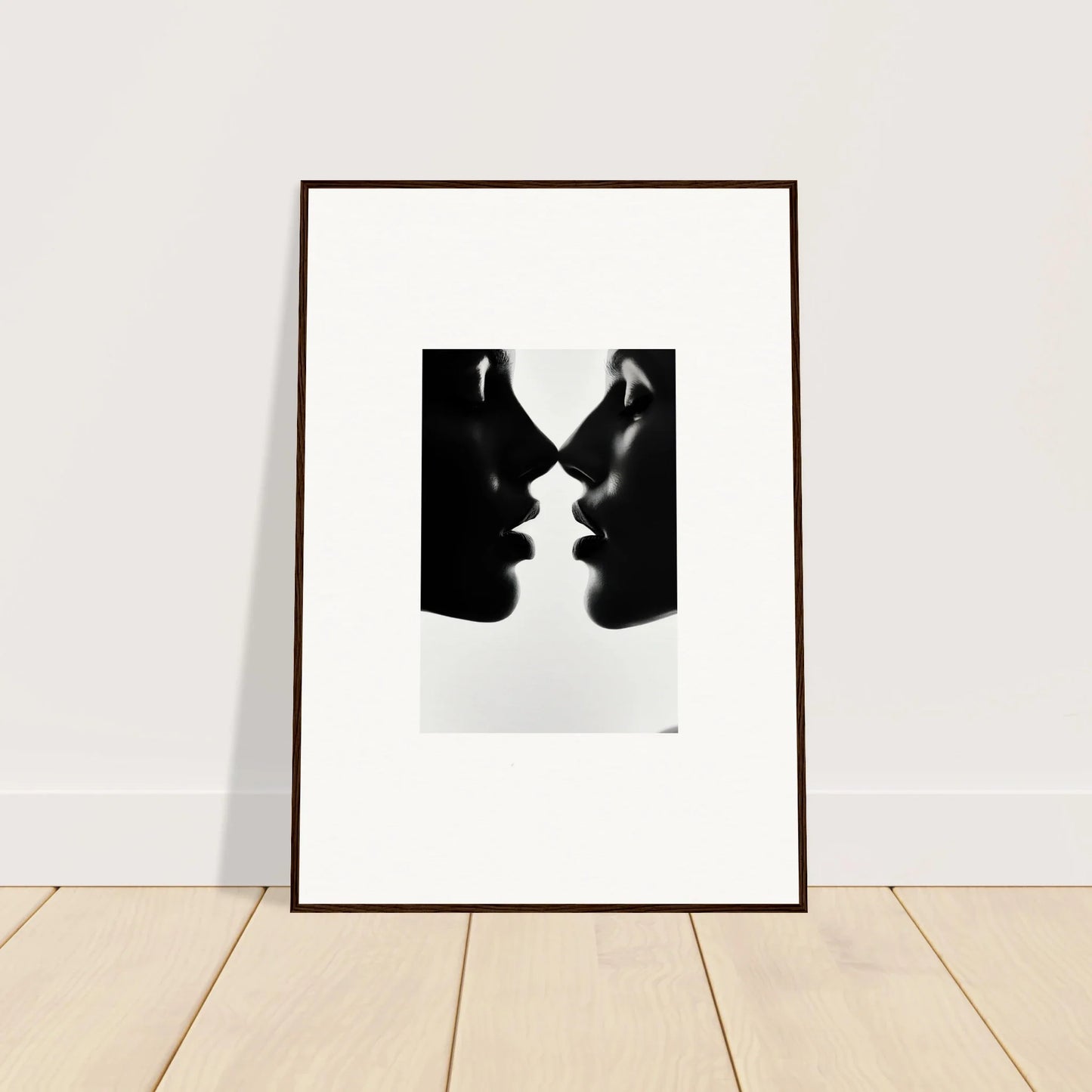 Framed black and white photo of two silhouettes in Whispers Kiss Universes art piece