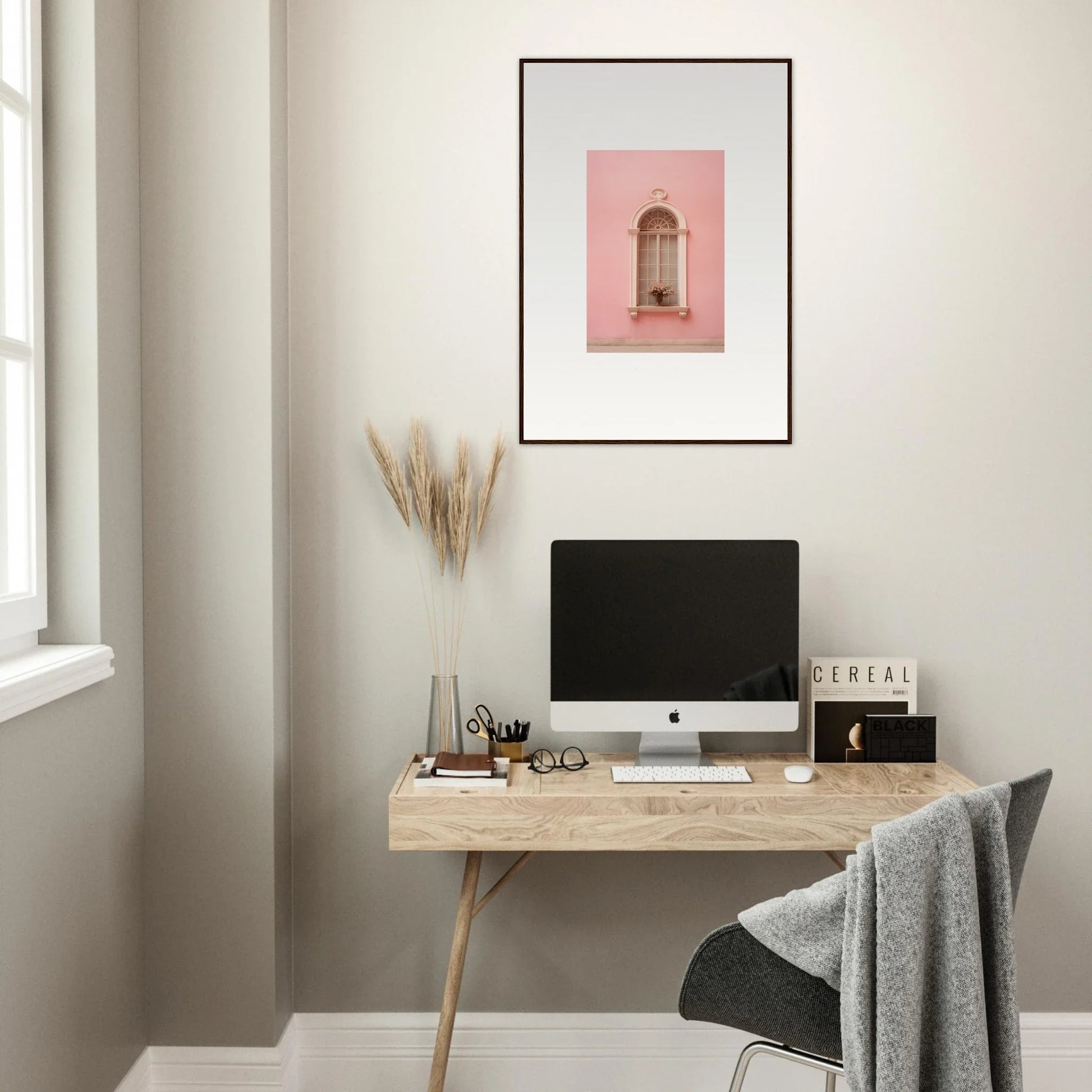 Minimalist wooden desk with iMac, showcasing Pinky Flora Portal and framed wall art