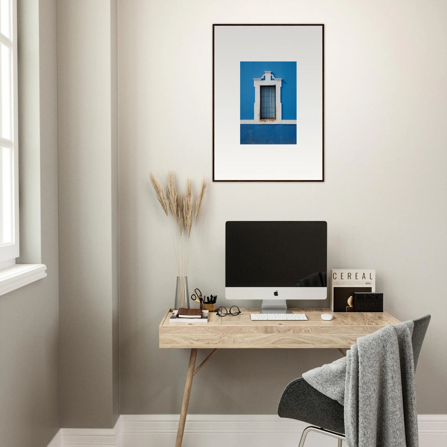 Minimalist wooden desk with iMac and Liquid Azure Quest framed wall art above