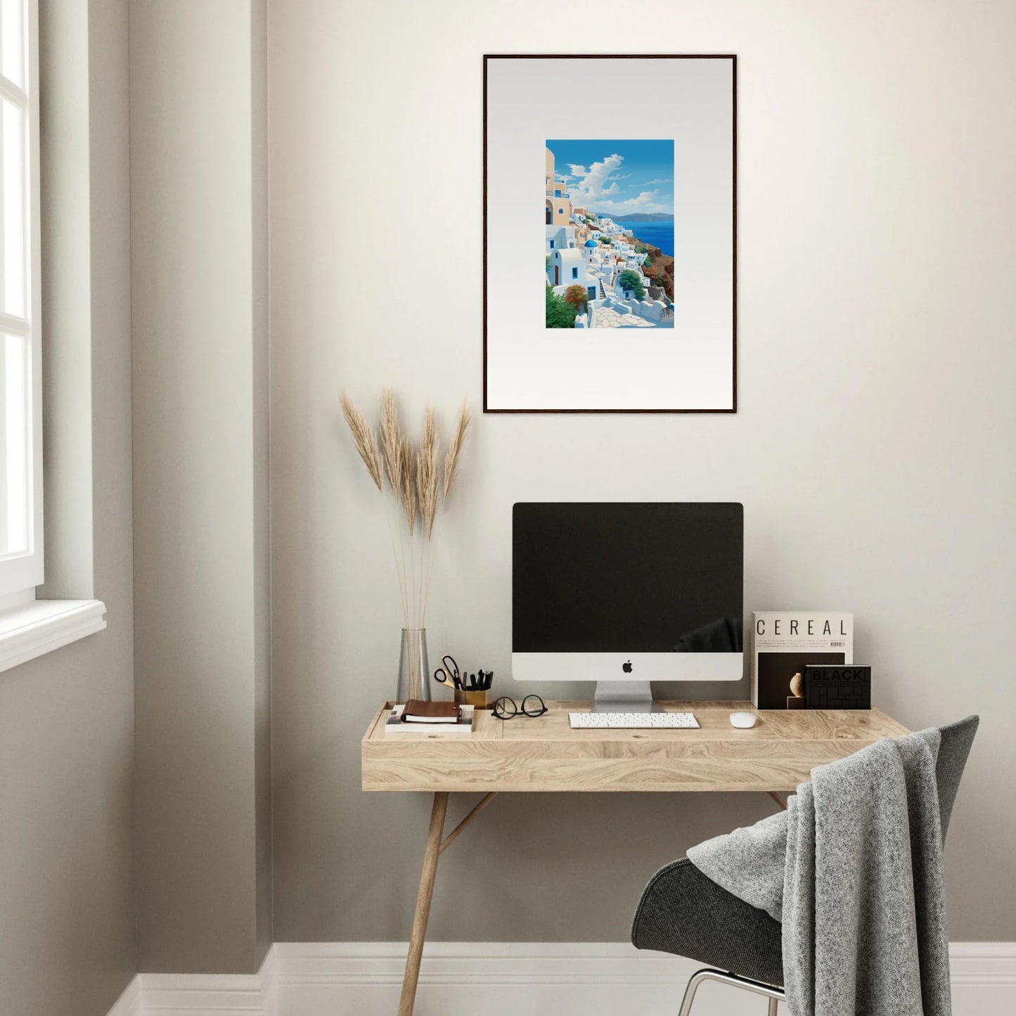 Minimalist wooden desk with iMac and Santorini artwork in Sunday Stahl Messiração