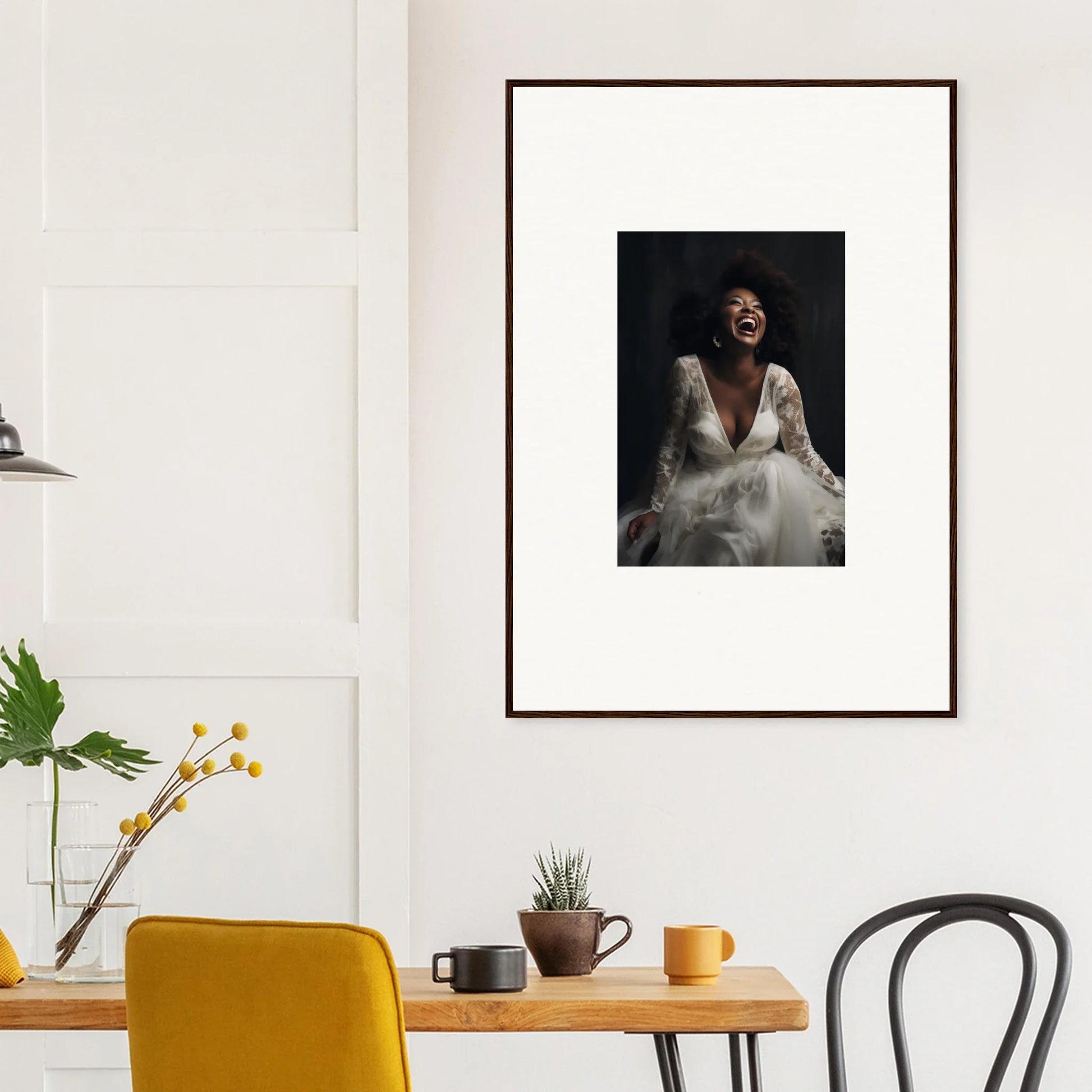 Framed black and white portrait on a wall, part of Timeless Essence Laughter art