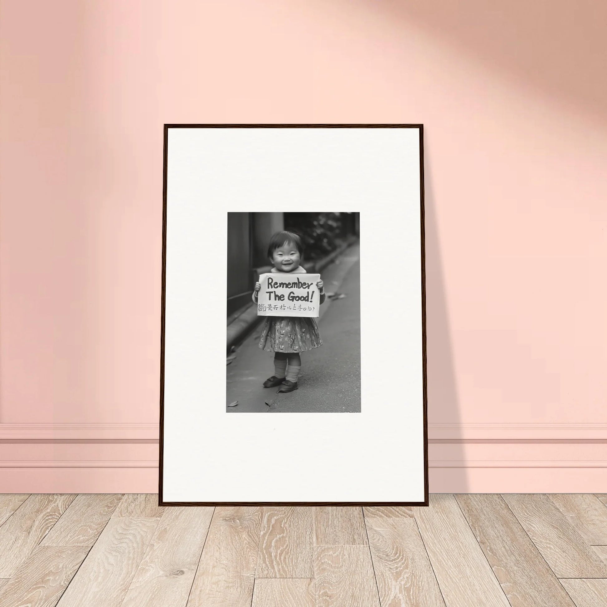 Framed black and white photo of a child holding a sign for Whimsy Echo Memory art