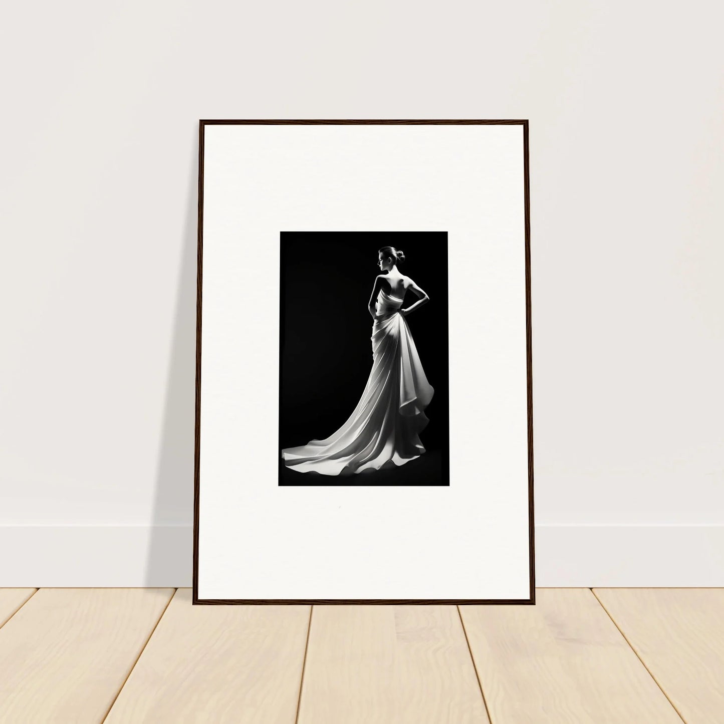 Framed black and white photo showcasing ephemeral grayscale elegance in a flowing gown