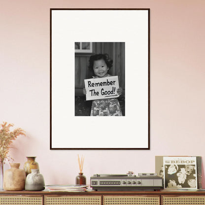 Framed black and white photo of a child with a Remember The Good sign for Essence Savor Whispers