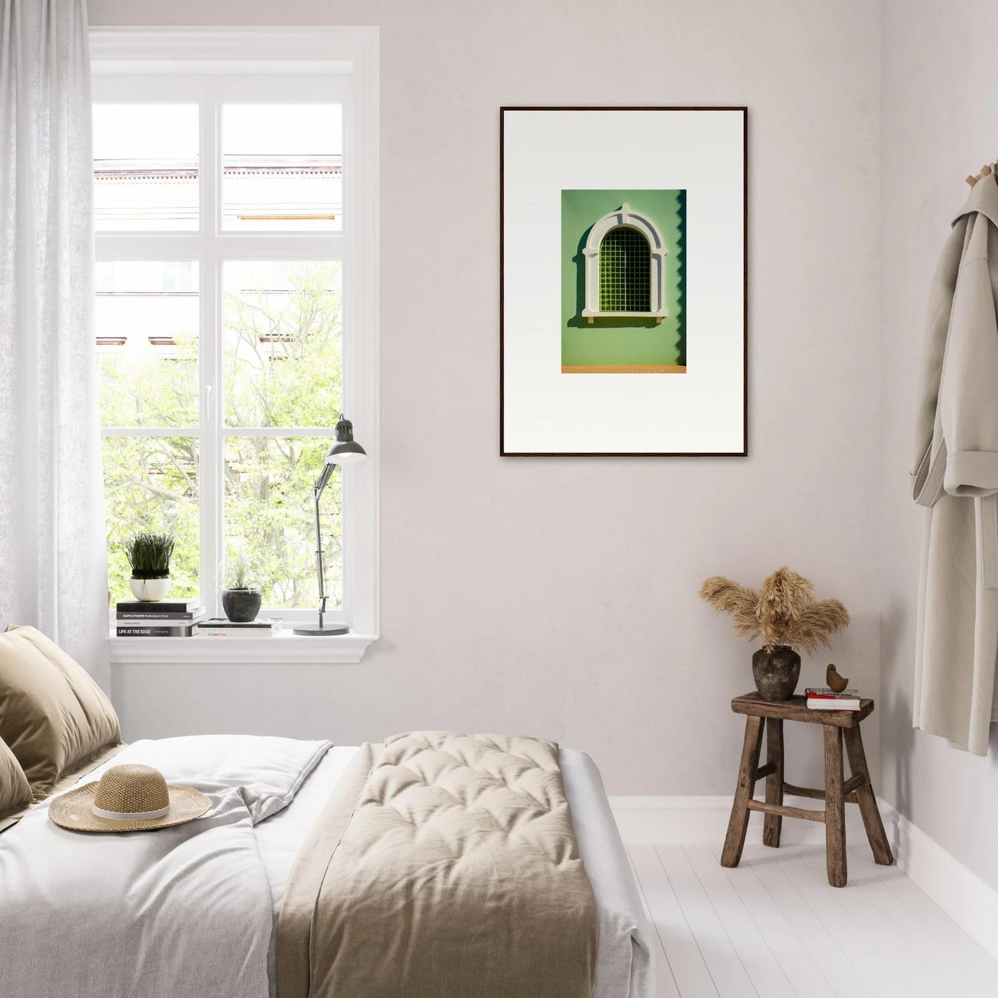 Minimalist bedroom featuring a Visible Equilibrium Window and framed green artwork