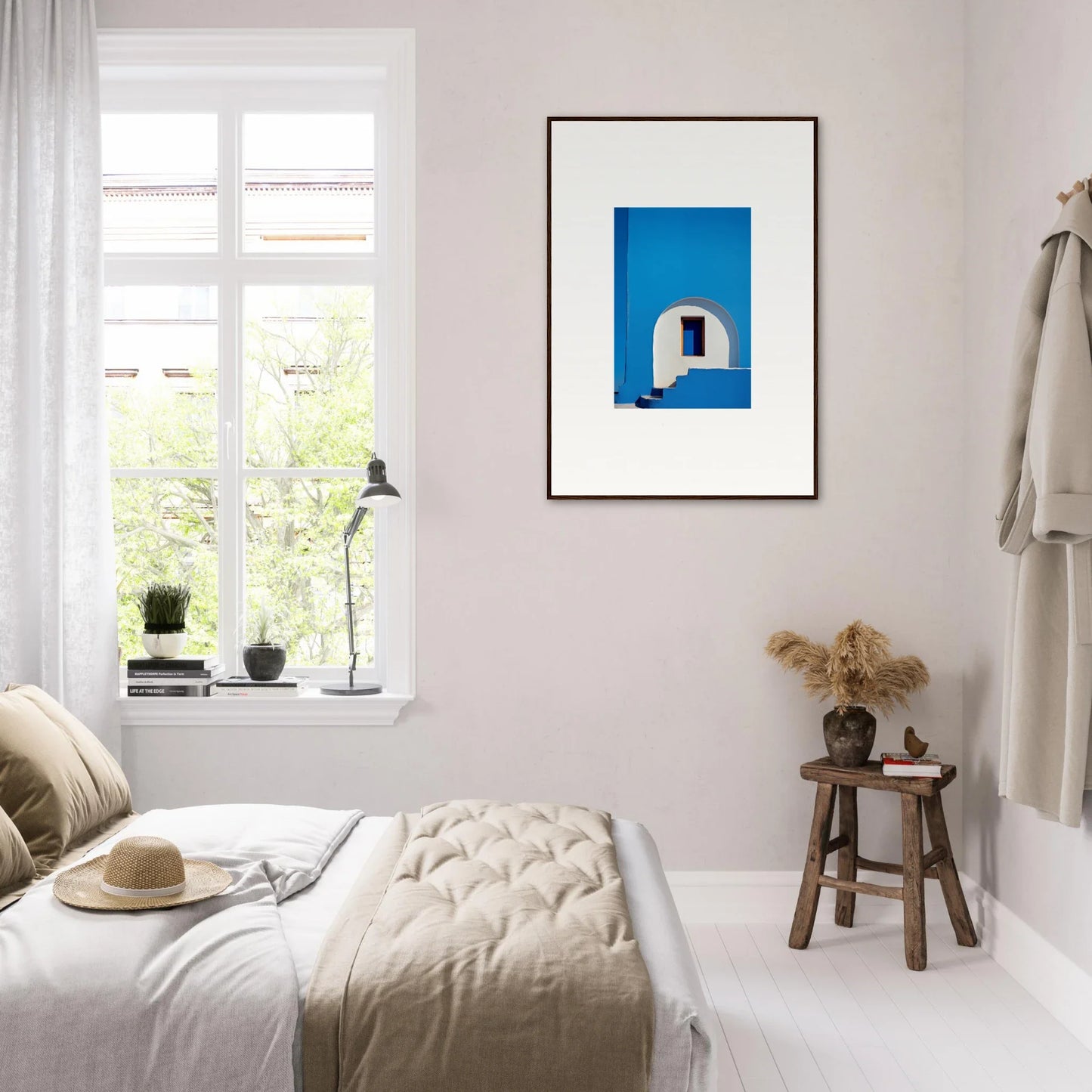 Minimalist bedroom featuring neutral tones and Doorway of Dreams framed wall art