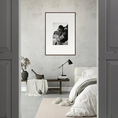 Framed black and white photo on light gray wall, showcasing Triumphant Shadows Embrace