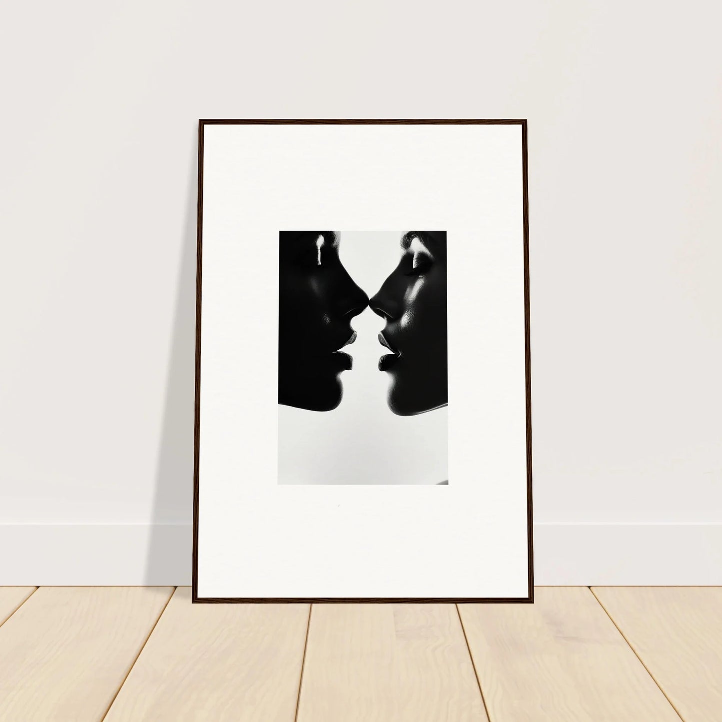 Framed black and white art of two silhouettes from Eclipsing Soulcare Kisses