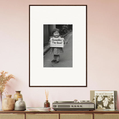 Framed black and white photo of someone with a sign saying Remember, I’m Good in Whimsy Echo Memory