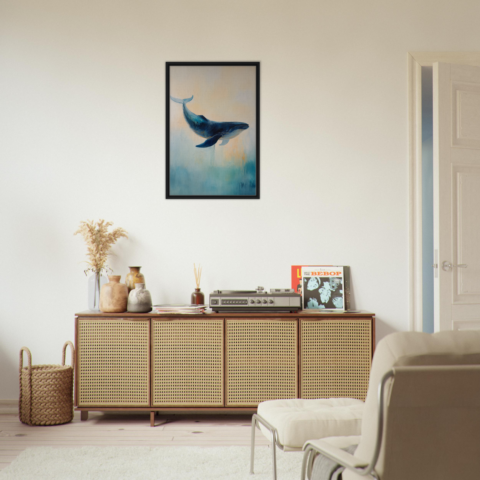 Wooden sideboard with cane-webbed doors and Whale’s Lucid Ballet framed artwork