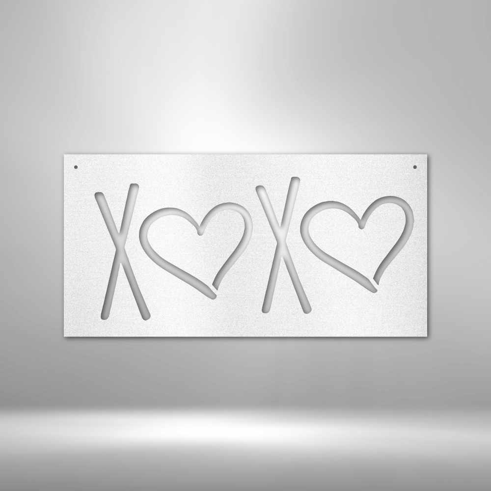 White rectangular sign with ’XOXO’ stylized using hearts for the O’s.