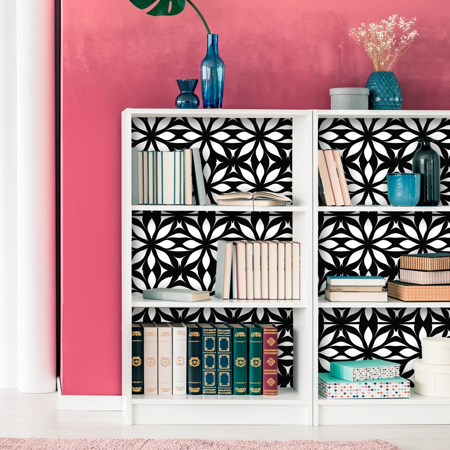 A white bookcase with black and white geometric pattern