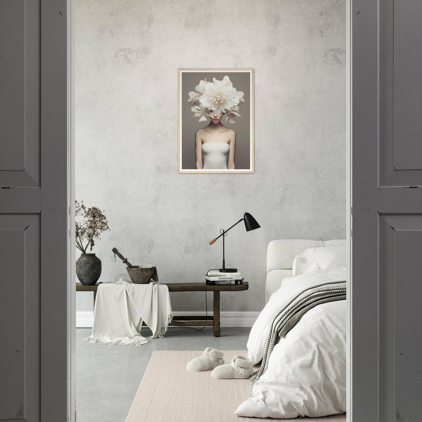 A white flower in a bedroom with a grey wall