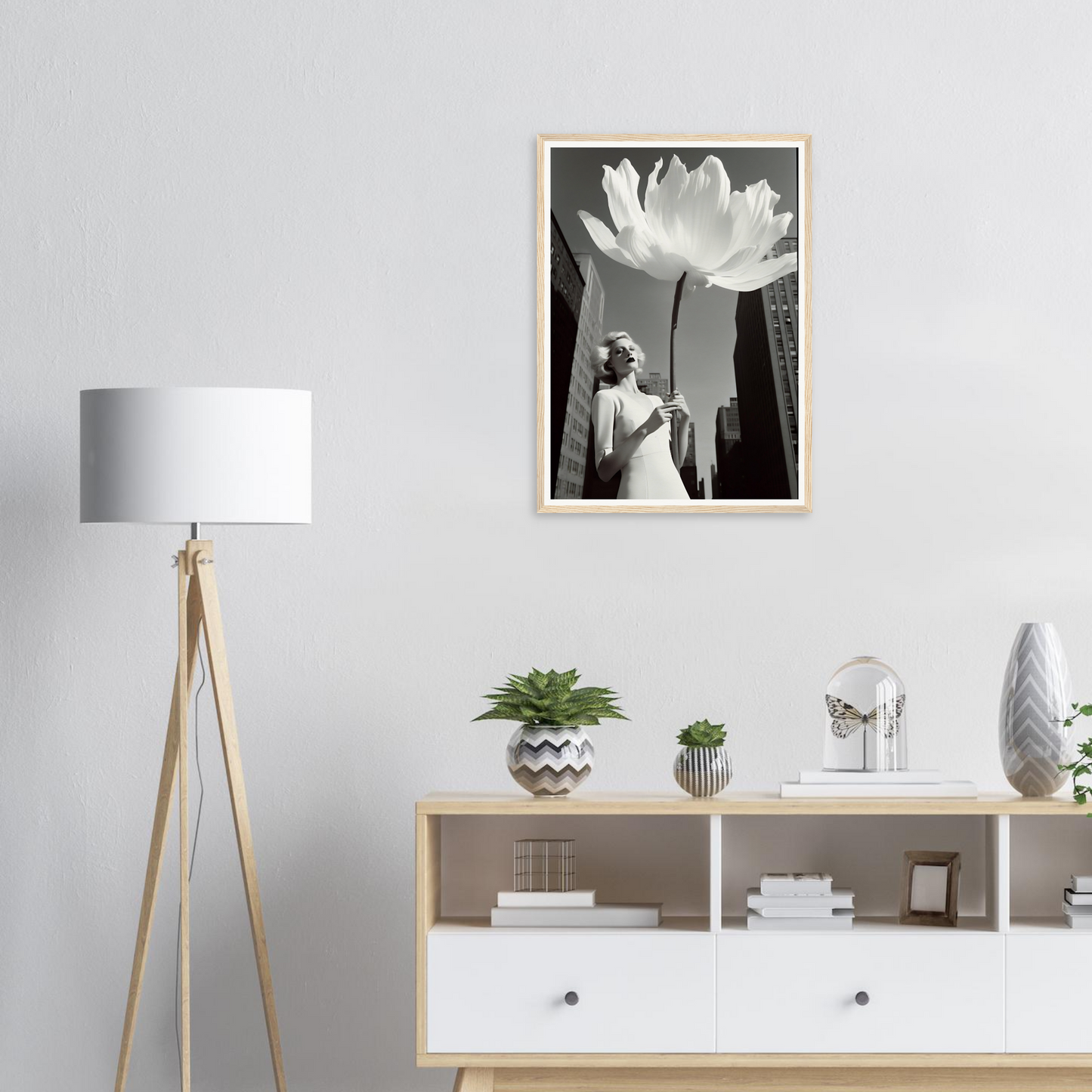 A white flower in a black and white photo on a wall