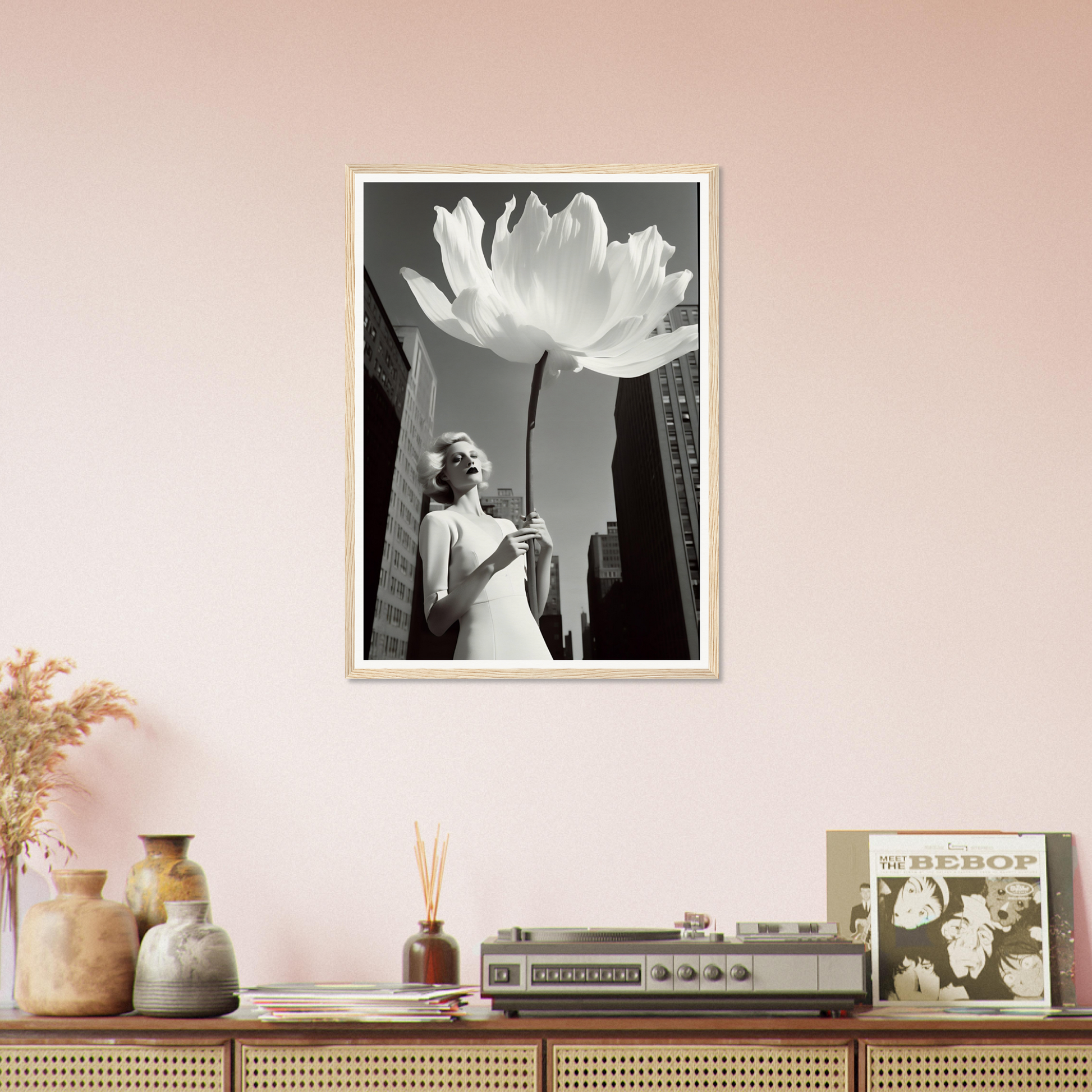 A white flower in a room with pink walls