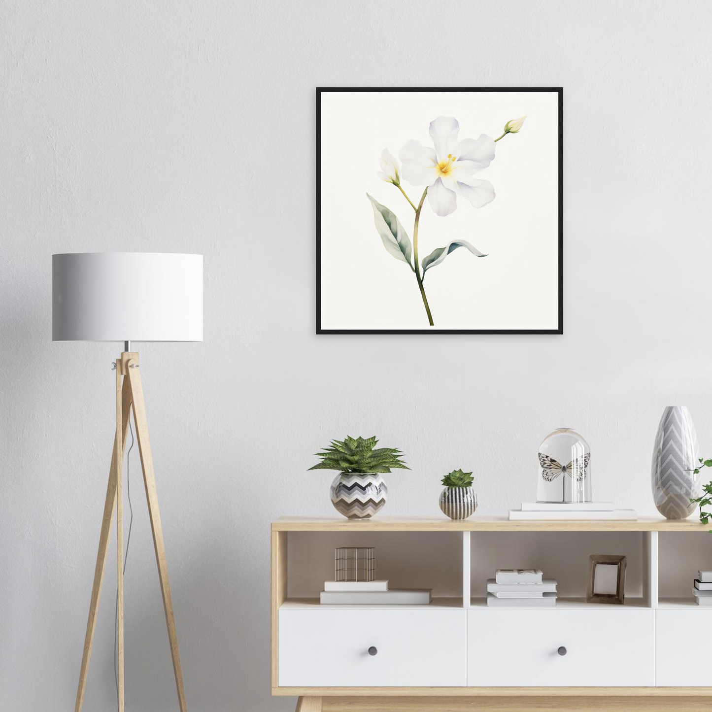 A white flower with yellow center on a white background framed in a room