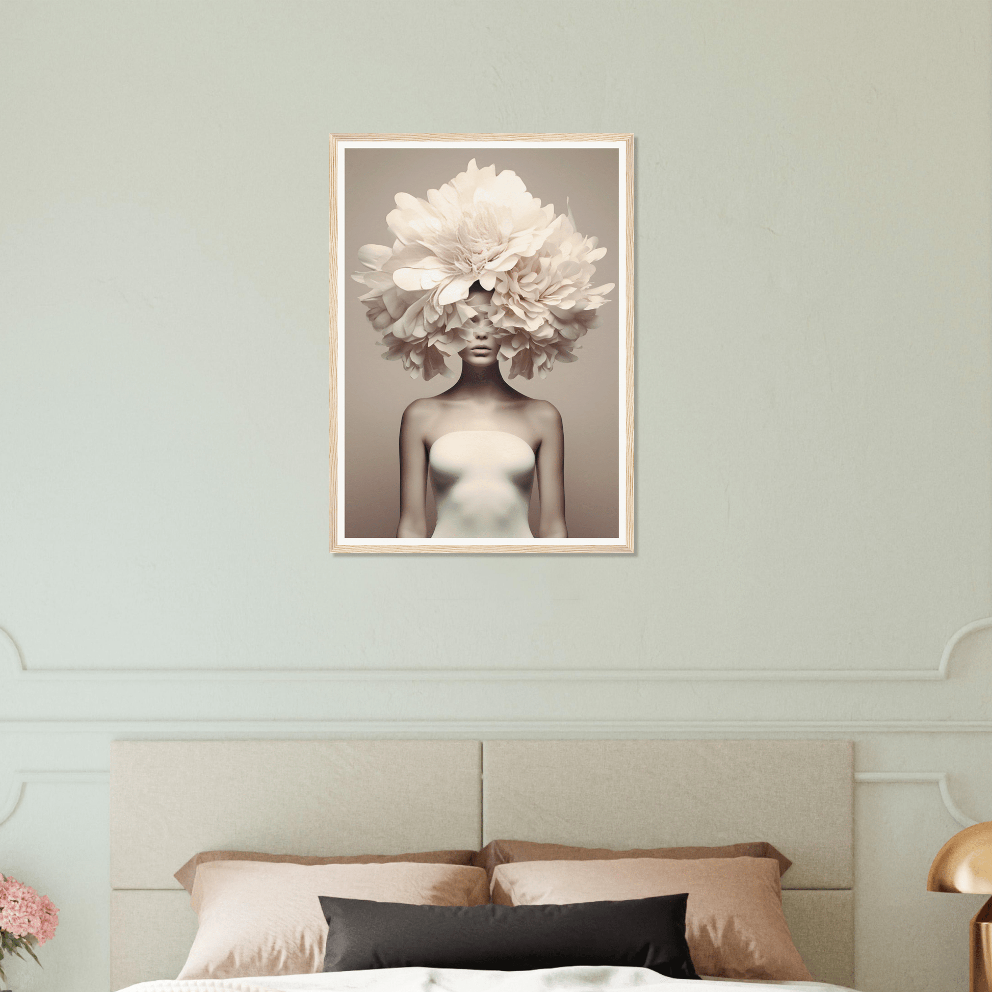 Artistic photograph of a figure with a large white peony flower covering the head, displayed as wall art above a bed.