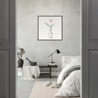 A white and pink flower in a vase on a grey wall