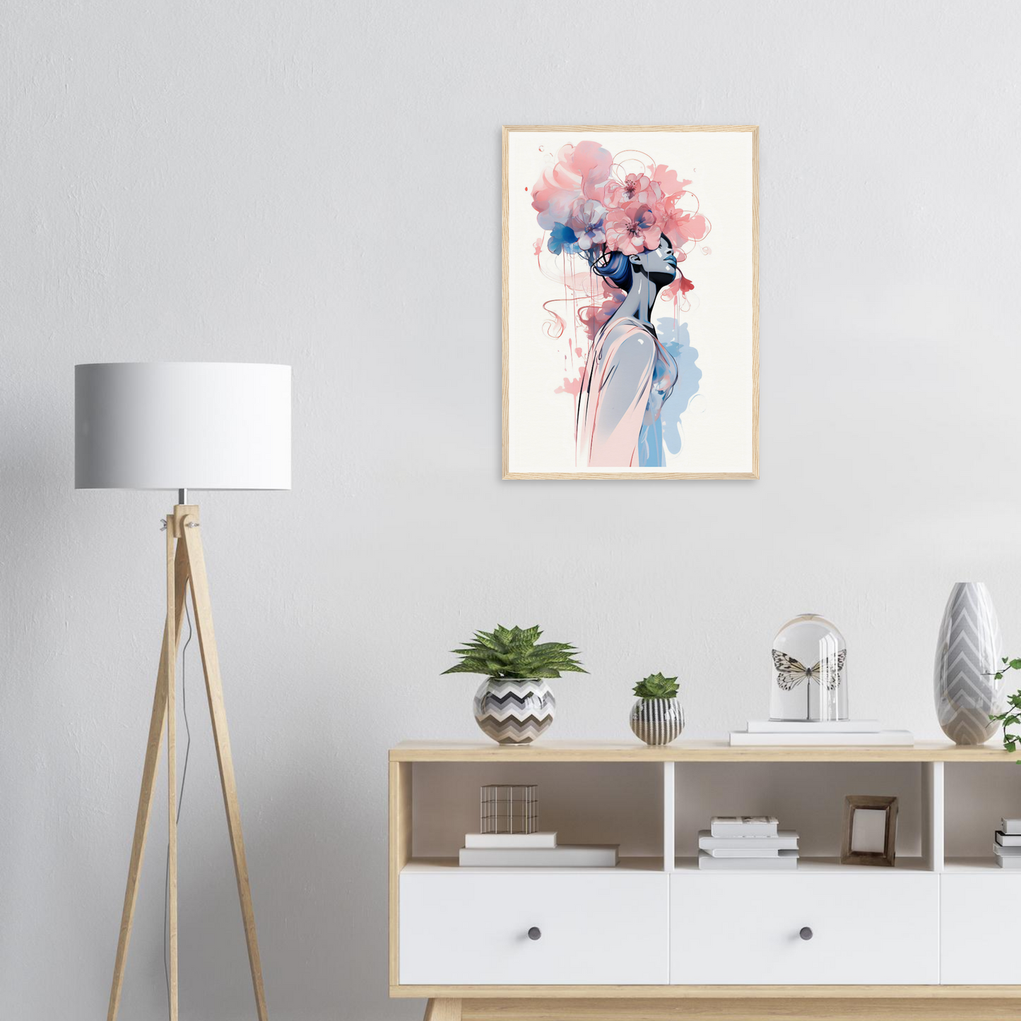 Framed watercolor painting of a figure with floral hair in soft pink and blue tones.