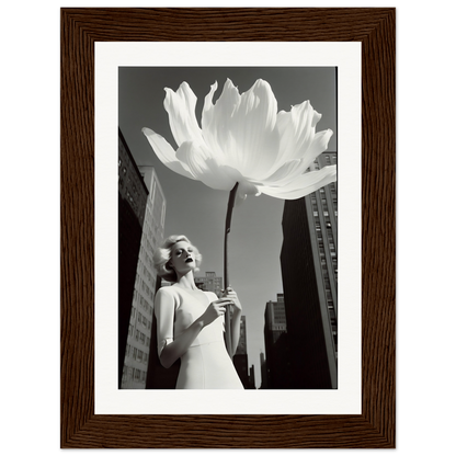 A woman holding a large white flower in front of a tall building