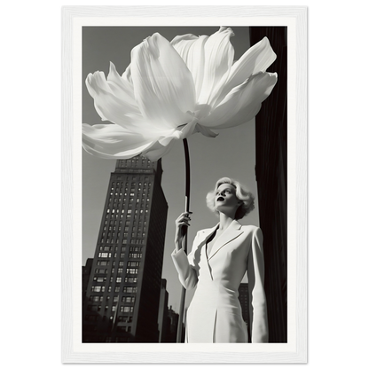 A woman holding a large white flower in front of a tall building