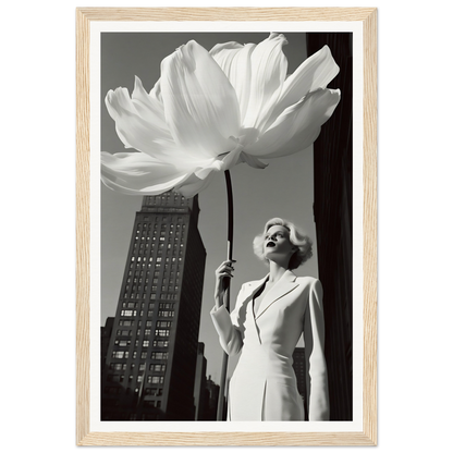 A woman holding a large white flower in front of a tall building