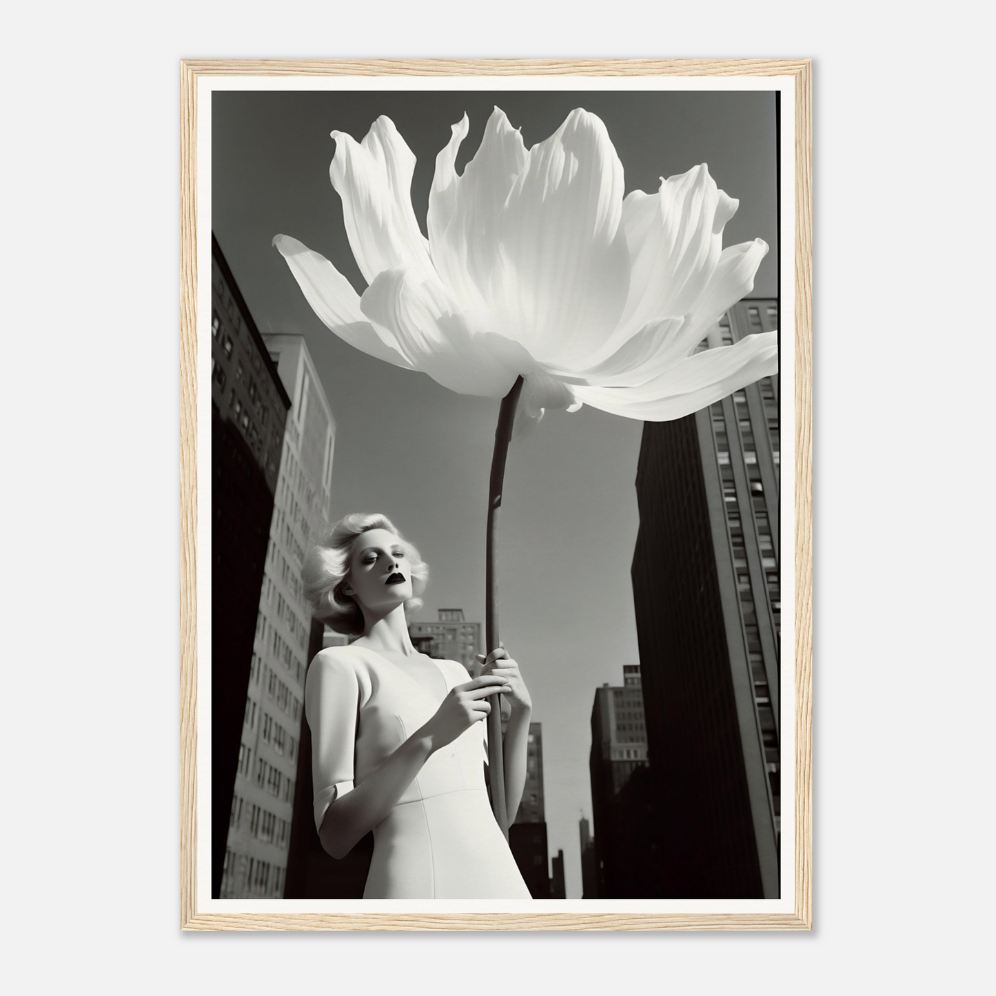 A woman holding a large white flower in front of a tall building