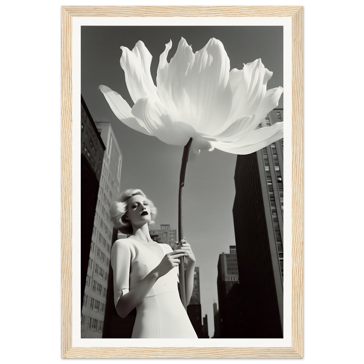 A woman in a white dress holding a large white flower