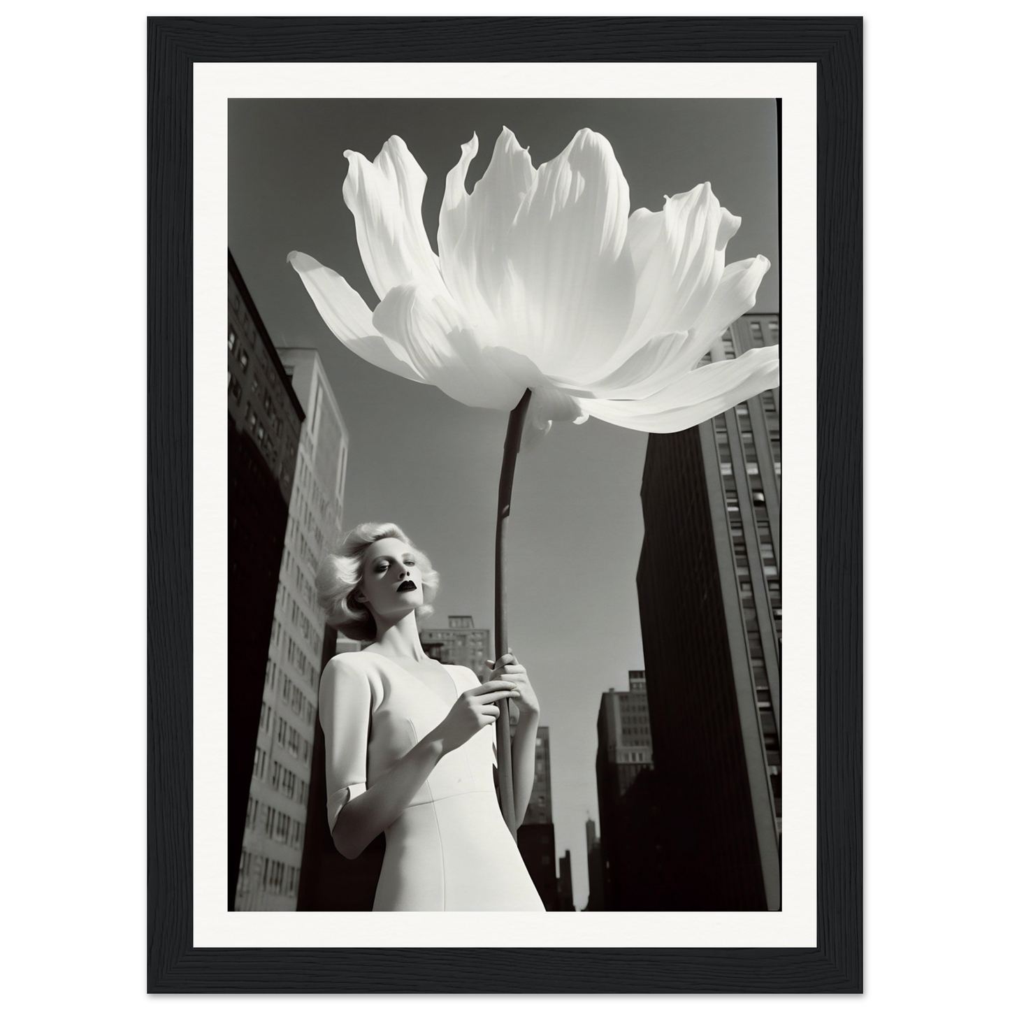 A woman in a white dress holding a large white flower