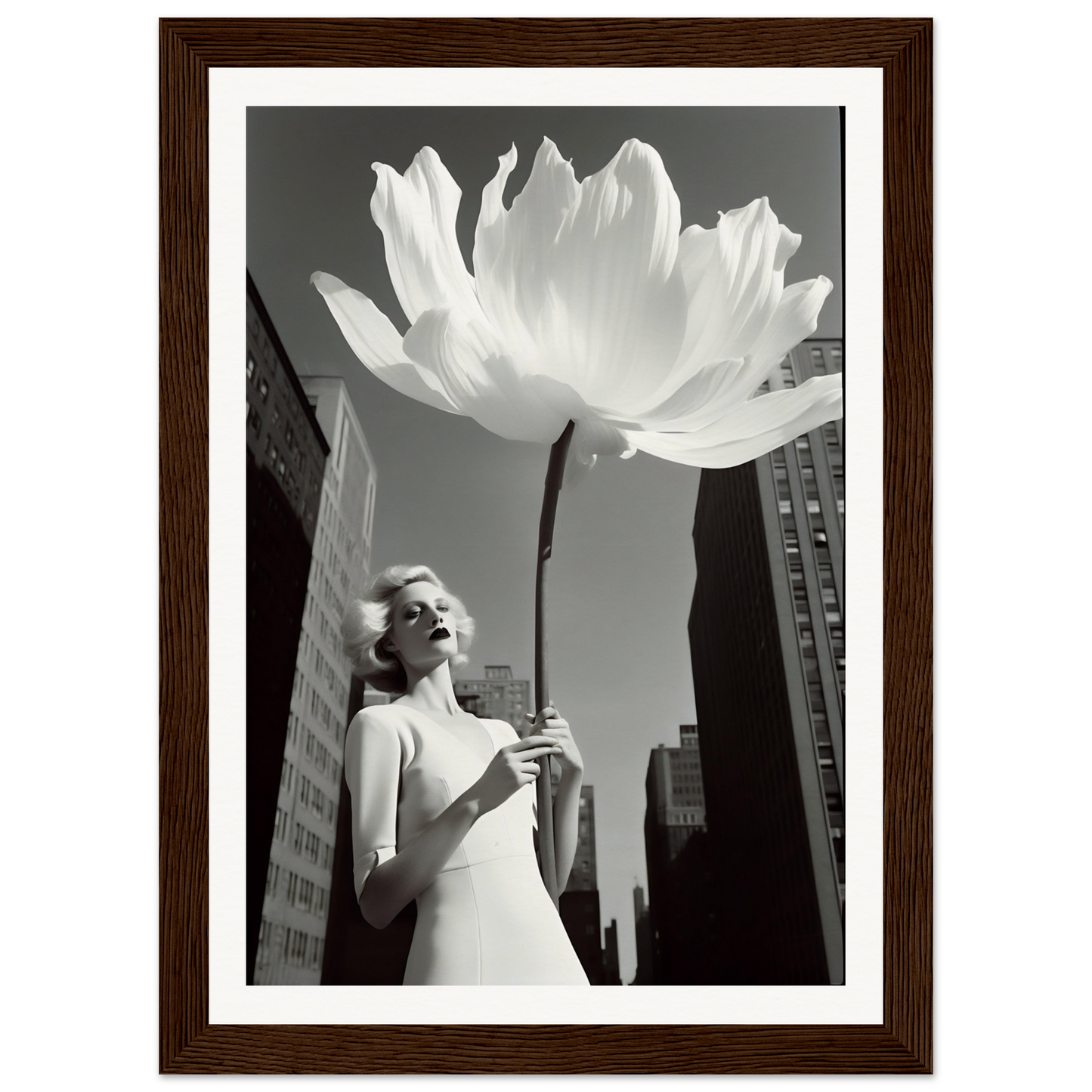 A woman in a white dress holding a large white flower