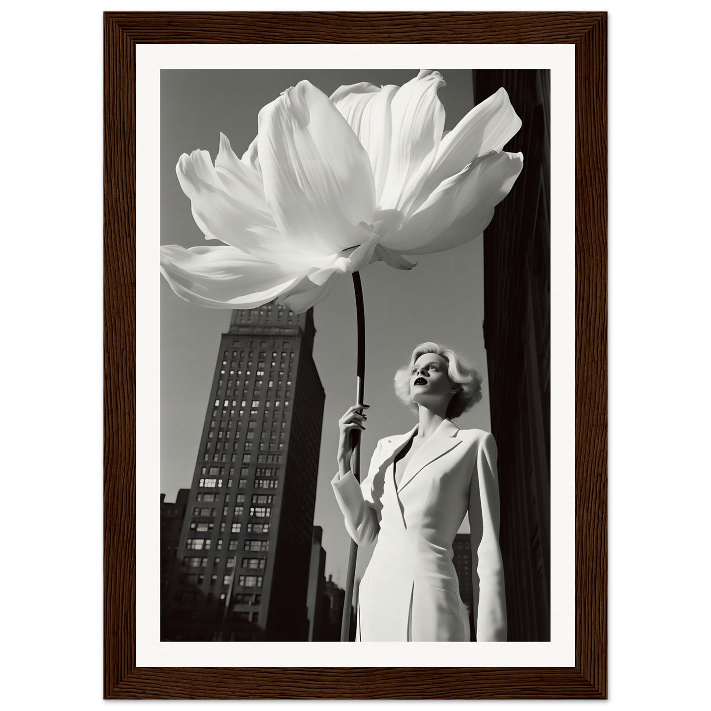 A woman in a white dress holding a large white flower