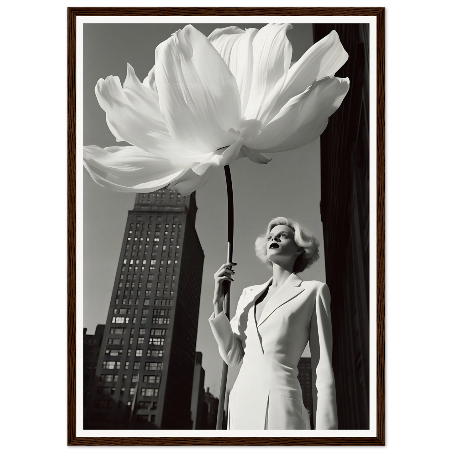 A woman in a white suit holding a large white flower