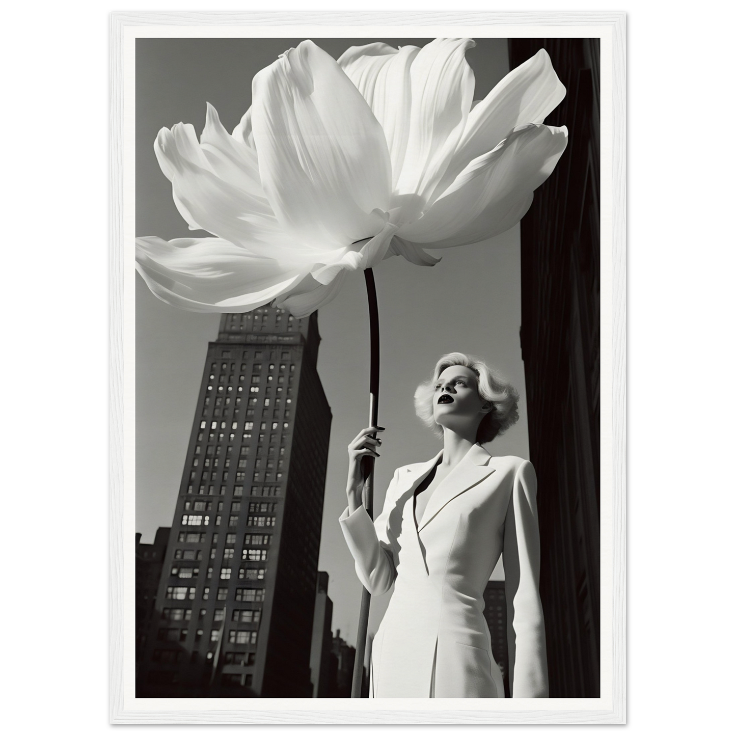 A woman in a white suit holding a large white flower