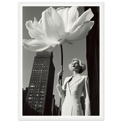 A woman in a white suit holding a large white flower